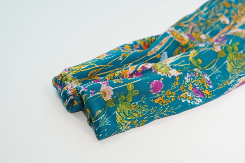 Beaded Floral Design on Teal Fabric